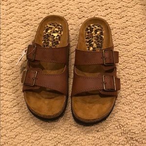 Brown buckled sandals.